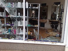 Various buildings in Birmingham have been damaged by rioting, including this hairdressing shop. Image: Clare Lovell.