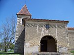 L'église Saint-Barthélemy de Malartic. La tour-clocher et le porche