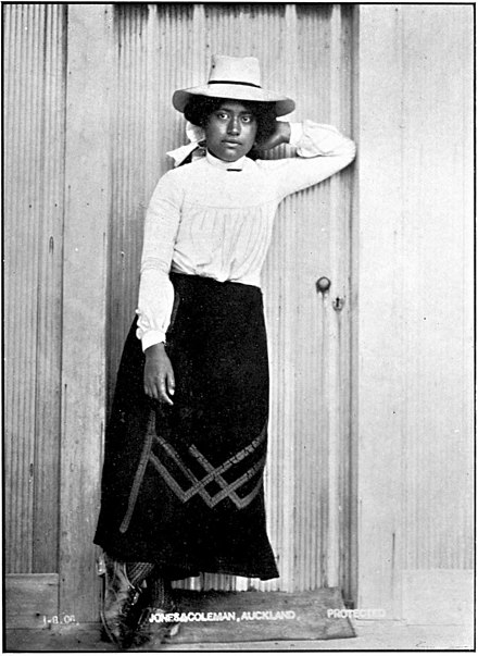 Young Māori woman in white hat.