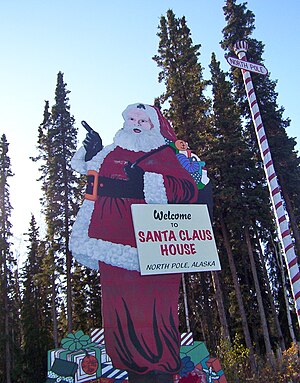 English: large wooden Santa Claus and "no...