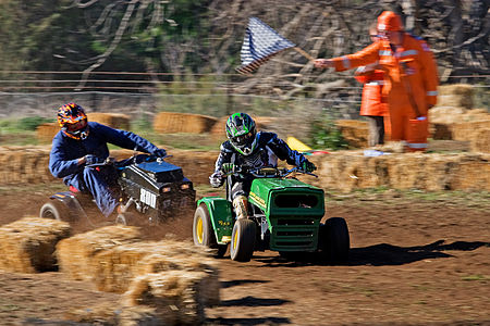 Riders cross the finish line of a lawn mower race in Swifts Creek], Australia