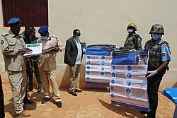 AMISOM Police officers hold COVID-19 awareness posters during a ceremony, 18 July 2020. 2020 07 18 Handover Bakiin Police Station-4.jpg