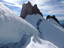 Rocky peaks protruding from undulating ice masses