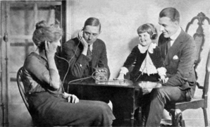 Photo of an American family in the 1920s listening to a crystal radio, from a 1922 advertisement for Freed-Eisemann radios in Radio World magazine