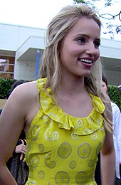 Dianna Agron in a yellow dress, smiling.