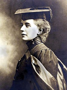 Black and white portrait graduation photograph of Elizabeth Ness MacBean Ross. She is wearing her graduation gown and cap, and looking to the left.