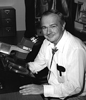 Eugene Shoemaker, pioneer impact crater researcher, here at a crystallographic microscope used to examine meteorites Eugene Shoemaker.jpg