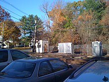 Several automobiles parked next to railroad tracks