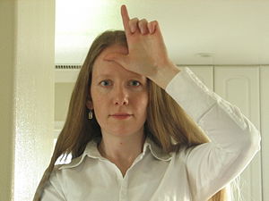 Woman doing the loser sign
