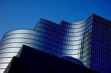 A curved glass-exterior office building