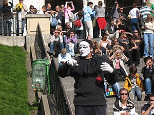 Parisian mime working for tips entertaining crowd.