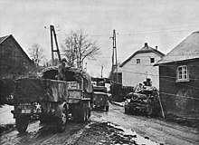 American soldiers of the 99th Infantry Division enter the Belgian village of Wirtzfeld, late 1944. 99th Infantry Division Moving Through Wirtzfeld.jpg