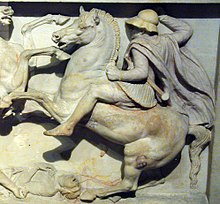 A heavy cavalryman of Alexander the Great's army, possibly a Thessalian. He wears a cuirass (probably a linothorax) and a Boeotian helmet, and is equipped with a scabbarded xiphos straight-bladed sword. Alexander Sarcophagus. Macedonian Army Thessalian.jpg