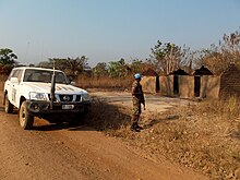 A member of the Beninese Contingent patrols Manono, following attacks by Mai - Mai rebels. Manono patrol.jpg