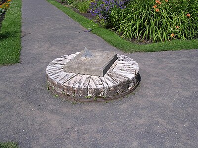 A millstone used to support a sundial at Domaine Joly in Lotbinière, Quebec.