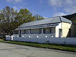 The property on which the church complex is situated was bequeathed to the London Missionary Society in 1842 by Mrs Dorothy Edwards, widow of the Rev. John Evans of Cradock. The parsonage, which was built in the Victorian style, dates from the period 1825. Type of site: Parsonage.