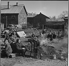 Soviet women having breakfast next to burning trash at a Finnish concentration camp in Petrozavodsk. Soviet women having breakfast at a Finnish concentration camp.jpg