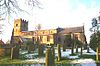 A long church with a battlemented west tower