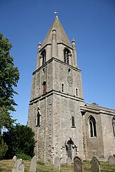 The square Anglo-Saxon tower; the top is later