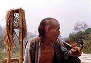 An Akha man smokes a pipe. Although this pipe was described as an opium pipe by the photographer, a true opium pipe requires an external heat source.  Still, opium can be smoked by mixing it with tobacco, as in madak and ack ack.