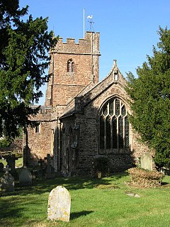 Stone building with arched windows and square tower.