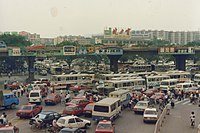 The east square of Guangzhou railway station in 1991. Notice the prevalence of traditional Chinese characters as brand logos during that time, including Jianlibao (), Rejoice () and ; only Head & Shoulders () printed in simplified. In Mainland China, it is legal to design brand logos in traditional characters, yet by 2020, apart from Jianlibao, the other three have changed to simplified.