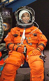 A smiling Nowak in her orange space suit