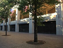 The first floor of the J. Edgar Hoover Building on Pennsylvania Avenue NW. The FBI opposed an arcade and retail shops here; the final design features a windowless wall with black granite infill panels at street level. Looking WNW at south facade - J Edgar Hoover Building - Washington DC - 2012.jpg