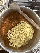 Adding cooked spaghetti and sauteeing to reduce