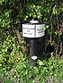 A black post supports a plaque which says on the left "Shardlow 92 miles" and on the right "Preston Brook".