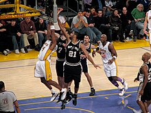 Duncan (No. 21) attempting to block Kobe Bryant's shot in a game against the Los Angeles Lakers at the Staples Center Spurs vs Lakers.jpg