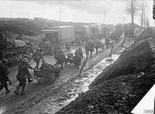 Narrow, crowded road with muddy shoulders