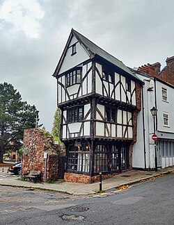 Front three quarters image of The House That Moved, showing its position on the corner, and clearly showing the half-timbered overhanging construction