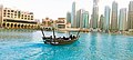 Boat in Dubai fountain pond in front of Dubai Mall