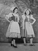 Two girls in traditional costume, take part in the recording of "Radio Small World" broadcast by radio station CKAC of Montreal.