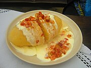 Cepelinai, a potato-based dumpling dish characteristic of Lithuanian cuisine with meat, curd or mushrooms Karmelavos Cepelinas.JPG