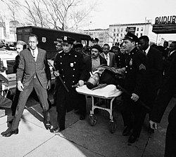 February 21, 1965: Malcolm X is assassinated as he was preparing to give a scheduled speech in Washington Heights Malcolm X on stretcher.jpg