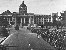 Soldiers occupy Seoul, South Korea as part of the May 16 coup that placed General Park Chung Hee in power Marines-march-on-Government-Building-Seoul 1962-05-17.jpg