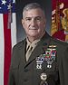 A color image of Glenn Walters, a white male in his Marine Corps Service A uniform. He is not wearing a hat, ribbons are visible. The Marine Corps flag and United States flag are visible in the background.