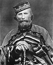 Giuseppe Garibaldi is considered an Italian national hero for his role in the Italian unification, and is known as the "Hero of the Two Worlds" because of his military enterprises in South America and Europe. Giuseppe Garibaldi (1866).jpg