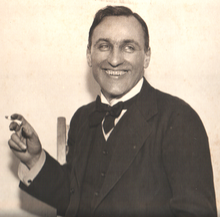 George Calderon smiling with cigarette.png