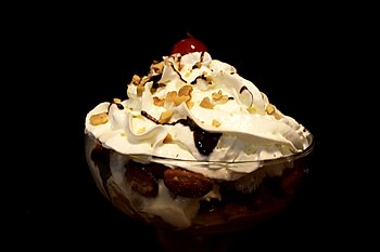 A classic ice cream sundae, complete with a ch...