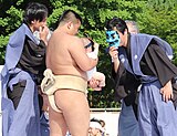 A man wears a mask to make a baby cry at the 2018 festival