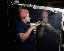 A female factory worker works to assemble a dive bomber in Nashville, 1943. Rosie the Riveter (Vultee) DS.jpg