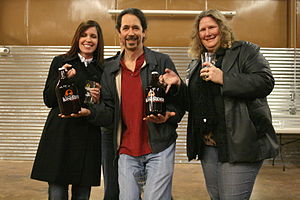 English: Visitors posing with bottles of LoneR...