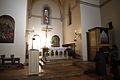 Afternoon sunlight shines on the cross through the rose window