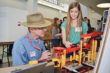 A high school student explains her engineering project to a judge in Sacramento, California, United States (2015). Brad Call judges an electric marble sorter (17182097775).jpg
