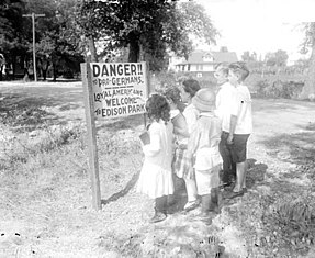 Anti-German sentiment obliterated the perspectives of German American citizens as being intellectuals, common folk, and prestige to being distrusted. Children standing in front of an anti-German sign.jpg