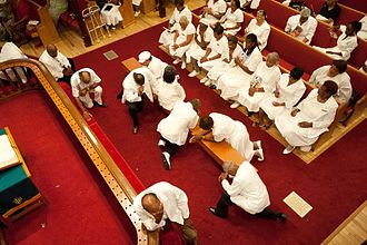 Methodists often seek the new birth and entire sanctification at the mourners' bench or chancel rails during services held in local churches, tent revivals and camp meetings (pictured are people praying at Mount Zion United Methodist Church in Pasadena). Mourners' Bench at Mt. Zion United Methodist Church.jpeg