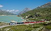 Two Rhaetian Railway ABe 4/4 III multiple units with a Bernina Express train on the Bernina Railway, passing Lago Bianco in 2010